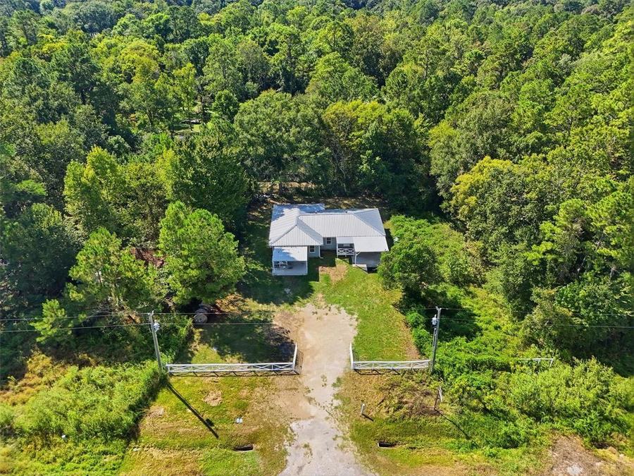 Aerial view of 22965 Highway 146 N and the surrounding neighborhood