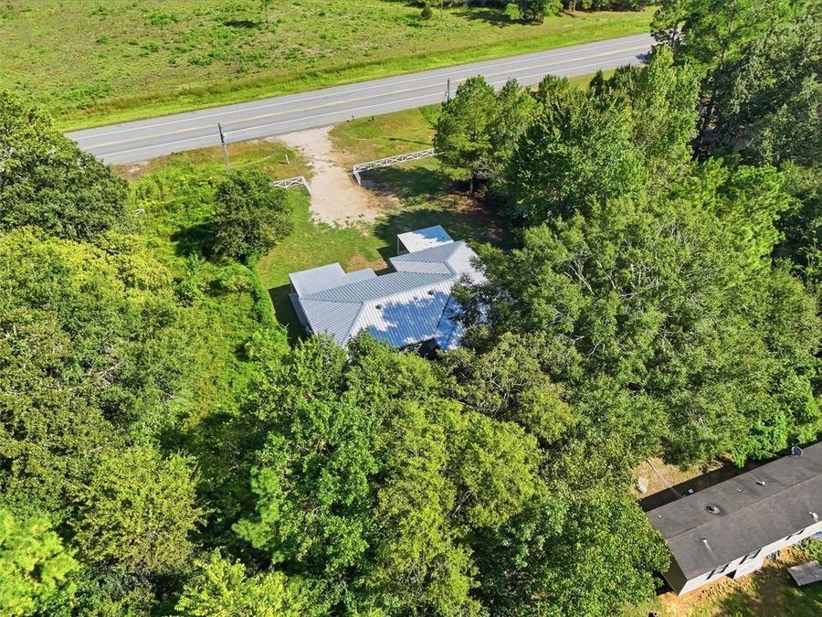 Aerial view of 22965 Highway 146 N and the surrounding neighborhood