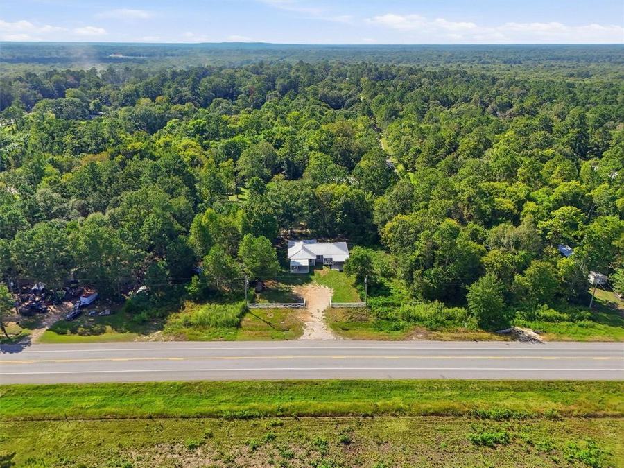 Aerial view of 22965 Highway 146 N and the surrounding neighborhood
